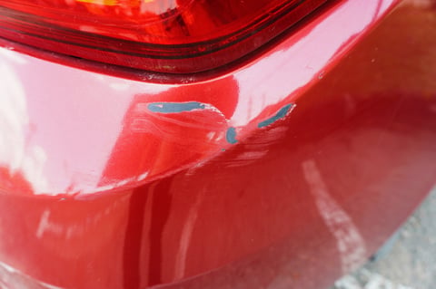 Car with scratches and paint damage before repair